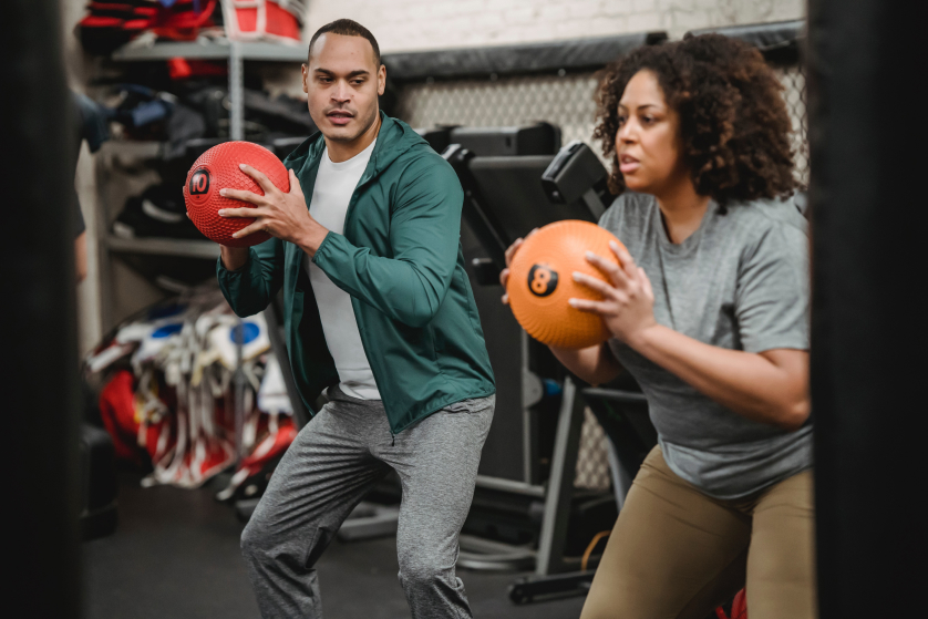 A guy and a girl are standing with a ball